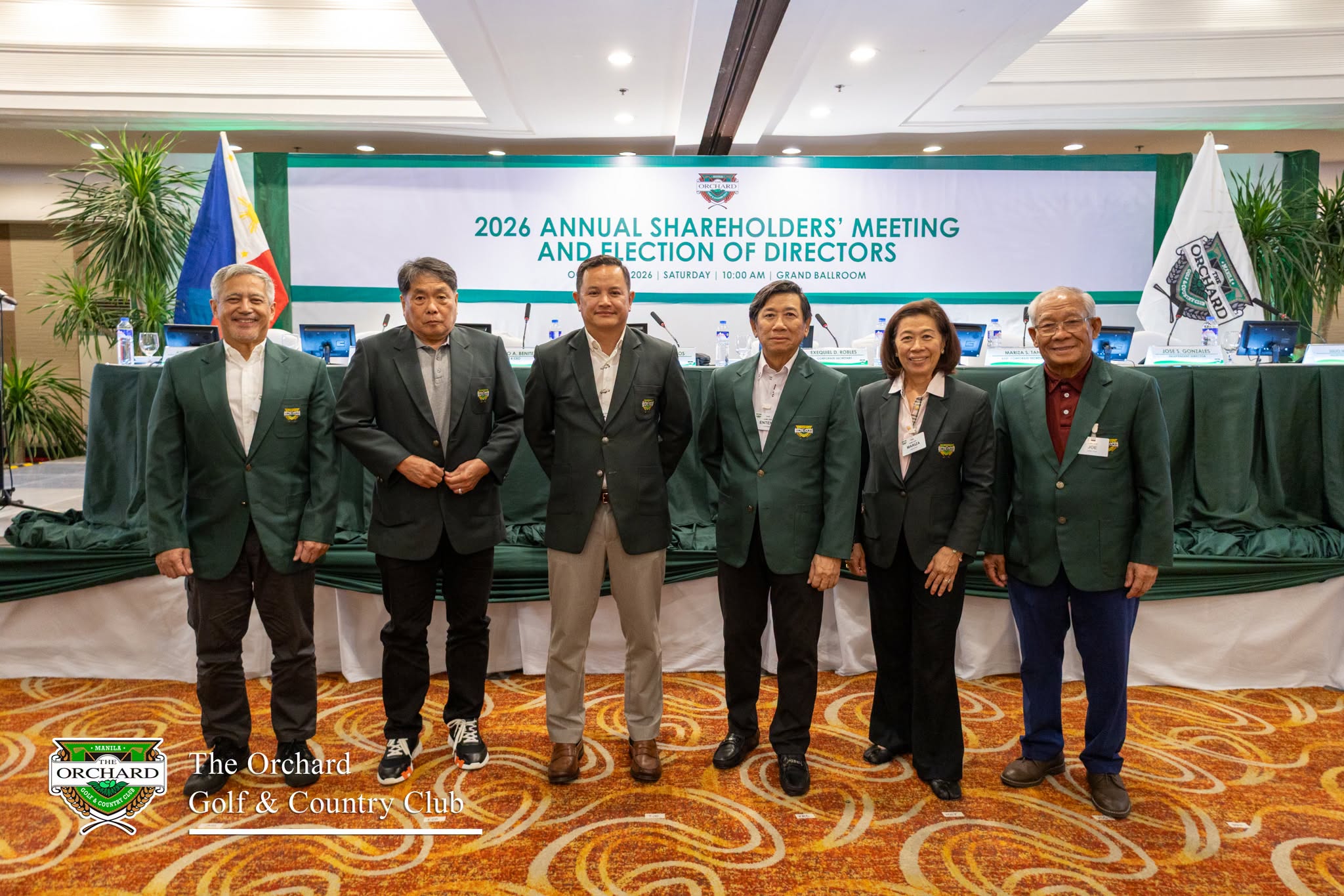 The 2026 Board of Directors of The Orchard Golf & Country Club standing together in front of the 2026 Annual Shareholders' Meeting and Election of Directors banner